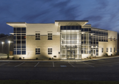 A large building illuminated at night, showcasing its architectural features against a dark sky