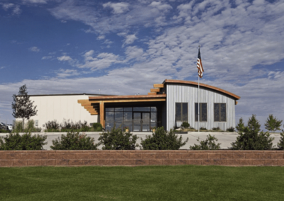 A contemporary building designed to resemble a modern home and flag hoisted in front of it